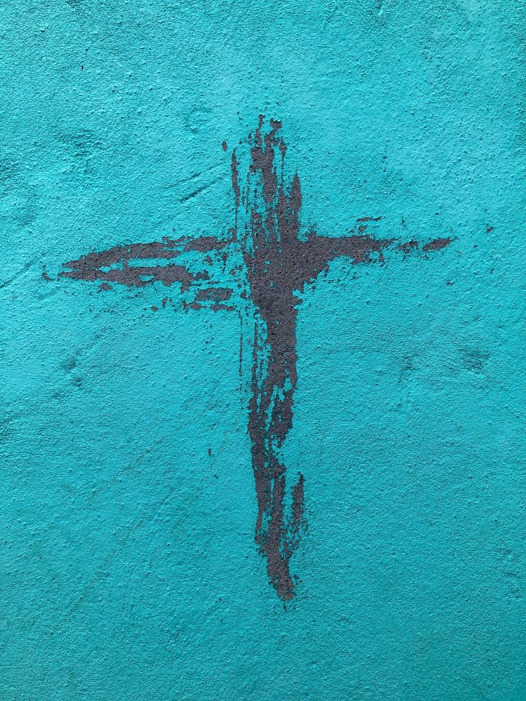 un mur de couleur bleue avec deux trainées de couleur rouge sang, esquissant la croix, symbole de la foi à l'épreuve de la souffrance